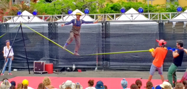 A clown balancing on a tightrope at Festival Mueca